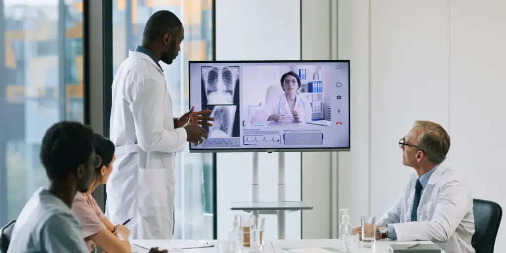 Doctor conducting a real-time video consultation with a patient in a modern hospital setting in 2025