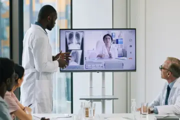 Doctor conducting a real-time video consultation with a patient in a modern hospital setting in 2025