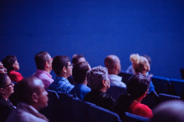 In-person audience at a hybrid conference streamed to remote attendees